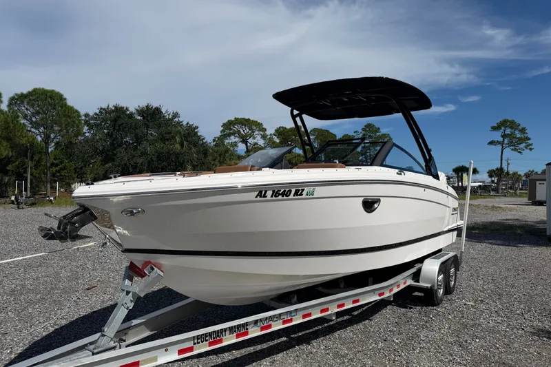 Slide: The Image of 2025 Cobalt R8 Outboard boat on trailer, parked outdoors under a clear sky. - 2