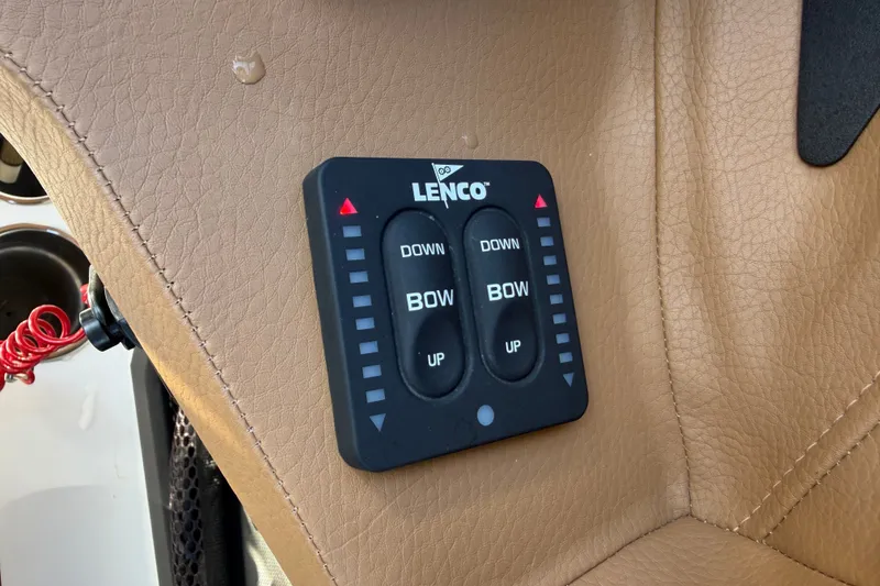 Slide: The Image of Lenco trim tab control on 2025 Cobalt R8 Outboard boat, beige leather panel. - 25