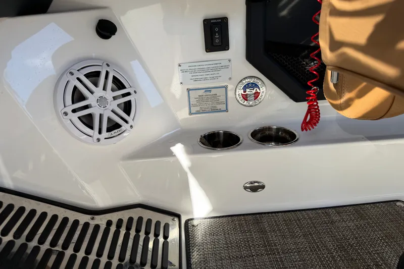 Slide: The Image of 2025 Cobalt R8 Outboard interior featuring speaker, cup holders, and control panel. - 31