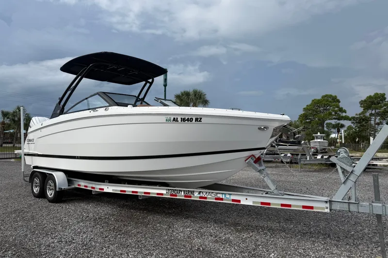 The Image of 2025 Cobalt R8 Outboard boat on trailer, parked outdoors under cloudy sky. - 0
