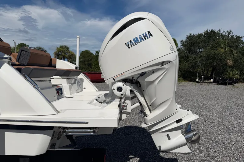 Slide: The Image of 2025 Cobalt R8 Outboard boat with Yamaha engine, parked on gravel under a clear sky. - 7