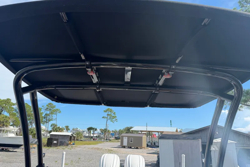 Slide: The Image of 2025 Cobalt R8 Outboard boat canopy with a scenic outdoor background. - 18