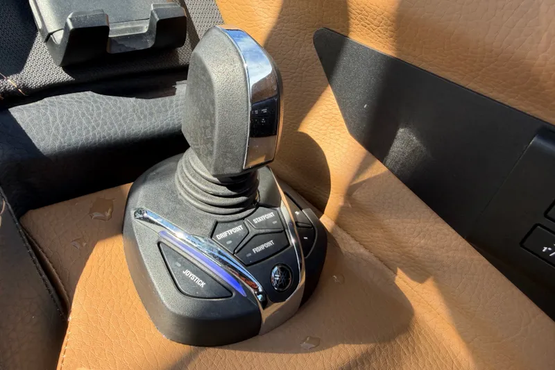 Slide: The Image of Joystick control panel in a 2025 Cobalt R8 Outboard boat, featuring various function buttons. - 28