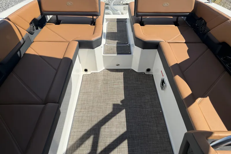 Slide: The Image of 2025 Cobalt R8 Outboard boat interior with tan leather seating and gray flooring. - 13