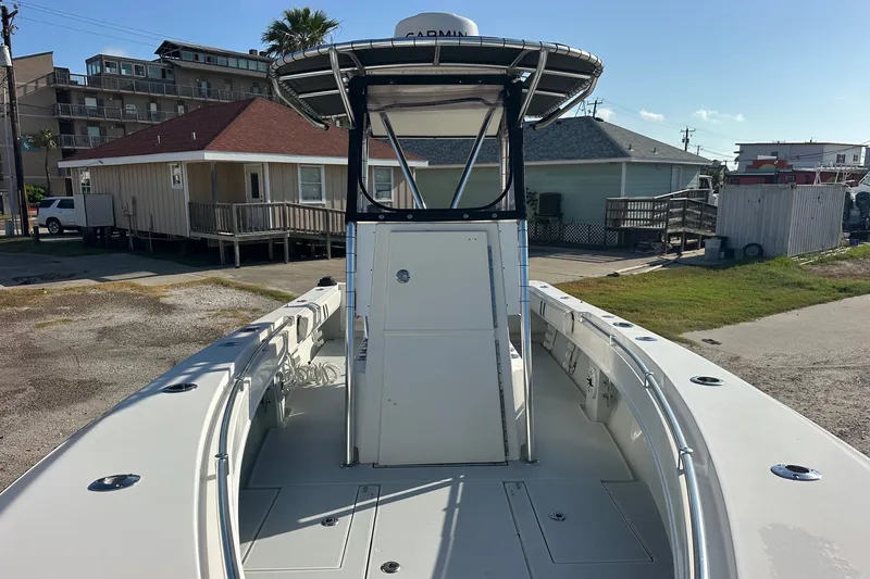 Slide: The Image of 2005 Contender 23 Tournament boat docked near coastal houses. - 6
