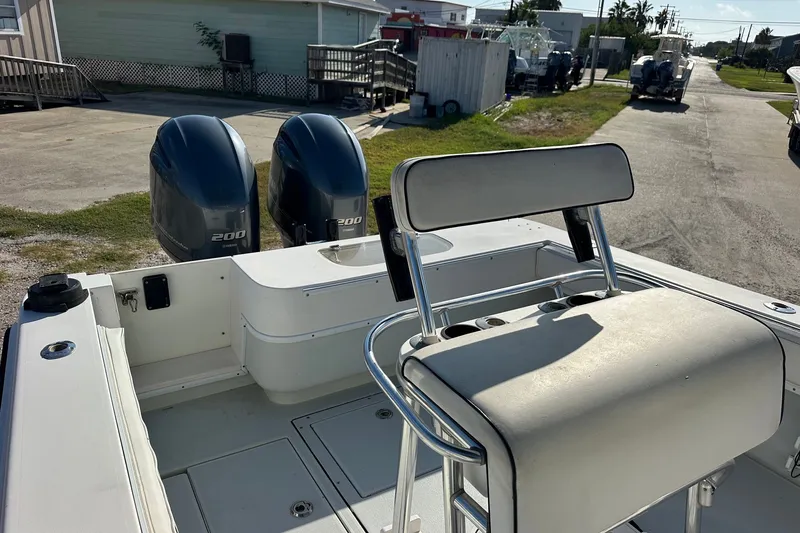 Slide: The Image of 2005 Contender 23 Tournament boat with dual 200 horsepower engines, docked outdoors. - 9