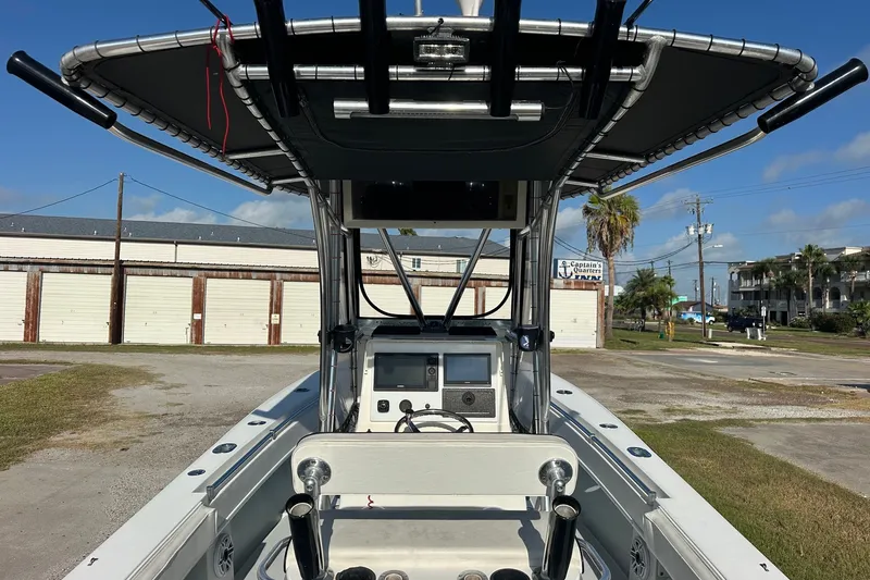Slide: The Image of 2005 Contender 23 Tournament boat with T-top and console, parked outdoors. - 3