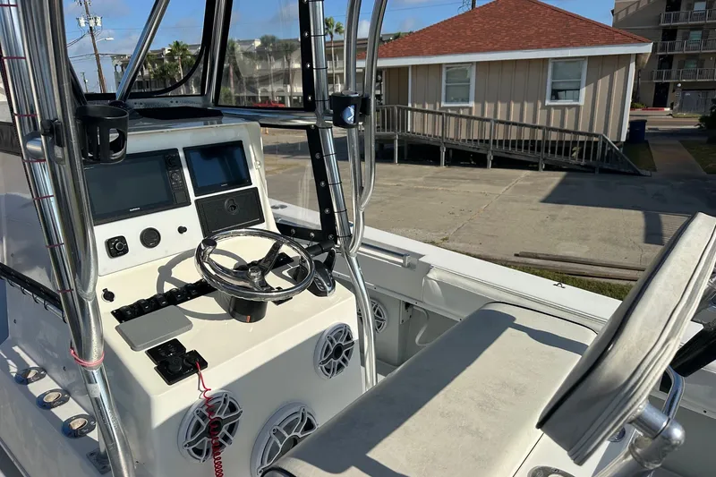 Slide: The Image of 2005 Contender 23 Tournament boat cockpit with steering wheel and navigation controls. - 5