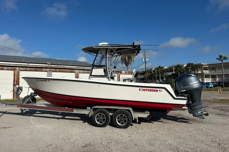 Slide: The Image of 2005 Contender 23 Tournament boat on trailer with Yamaha outboard, parked outdoors. - 1