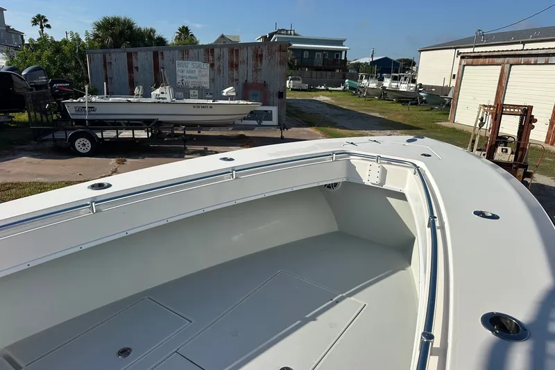 Slide: The Image of 2005 Contender 23 Tournament boat in a yard, showcasing spacious deck and sleek design. - 8