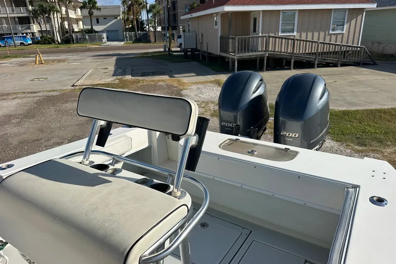 Slide: The Image of 2005 Contender 23 Tournament boat with dual 200 horsepower engines, docked near buildings. - 10