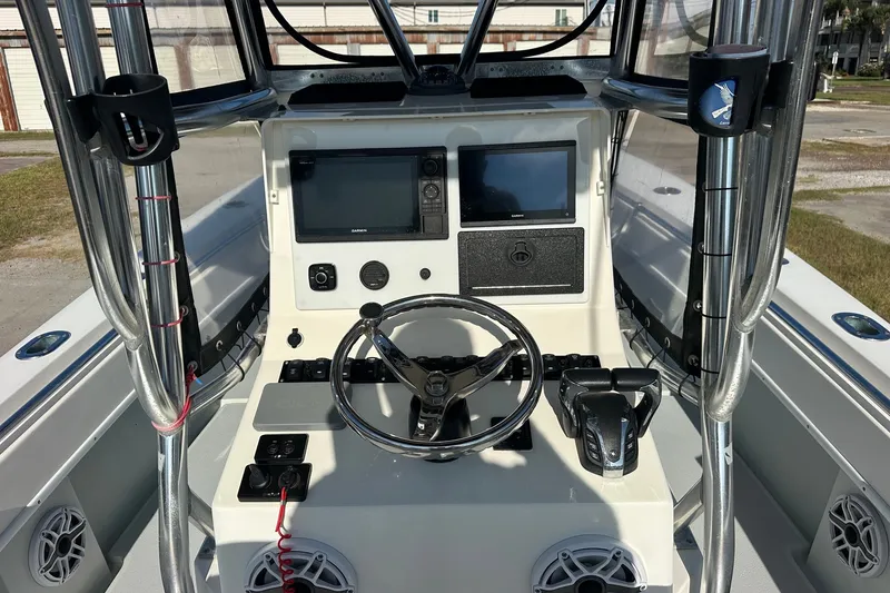 Slide: The Image of 2005 Contender 23 Tournament boat dashboard with steering wheel and navigation screens. - 4