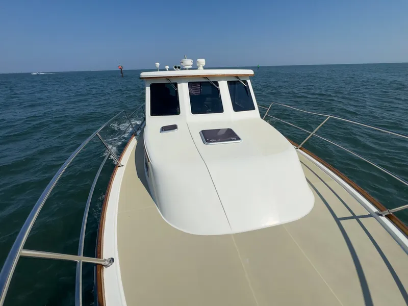 Slide: The Image of The 2002 Sabre 36 Express cruising on calm waters under a clear sky. - 42