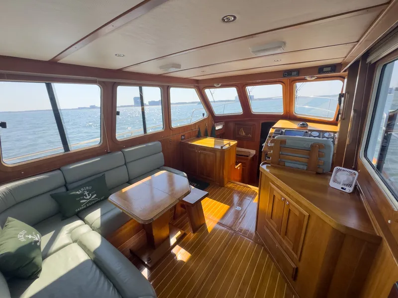 Slide: The Image of Interior of a 2002 Sabre 36 Express with wood finish and a view of the water. - 10