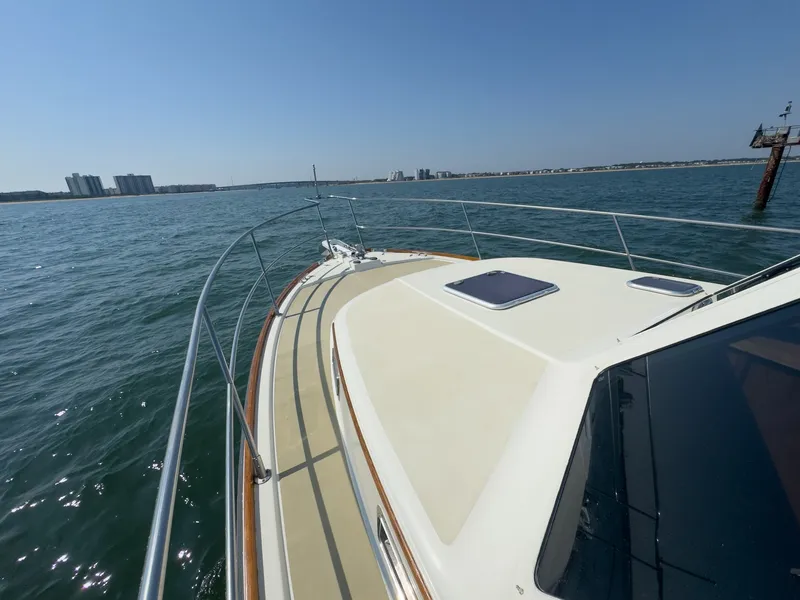 Slide: The Image of The image shows the deck of a 2002 Sabre 36 Express on the water. - 38