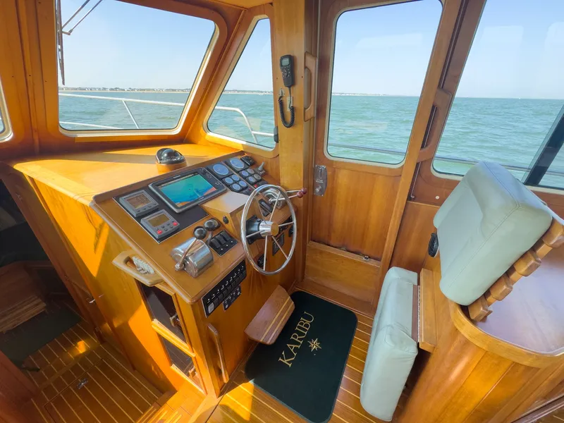 Slide: The Image of Interior view of a 2002 Sabre 36 Express helm station with wooden finish. - 6