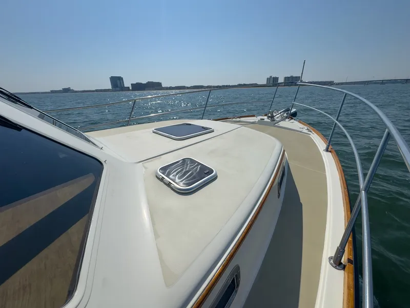 Slide: The Image of The image shows the deck of a 2002 Sabre 36 Express on the water. - 41