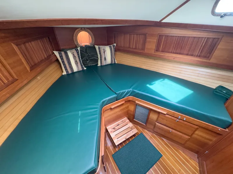 Slide: The Image of The 2002 Sabre 36 Express cabin features green cushions and wooden walls. - 26