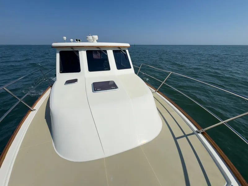 Slide: The Image of The 2002 Sabre 36 Express cruising on calm waters under a clear sky. - 43