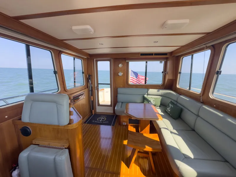 Slide: The Image of Interior of a 2002 Sabre 36 Express with wooden floors and gray upholstery. - 3