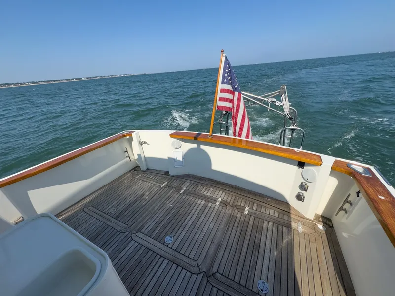 Slide: The Image of The image shows the stern of a 2002 Sabre 36 Express boat on the water. - 36