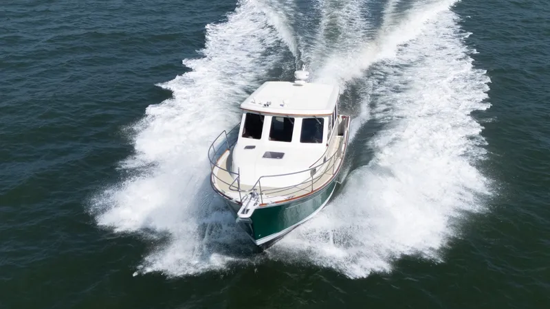 Slide: The Image of A 2002 Sabre 36 Express speeds across the water, leaving a white wake behind. - 1