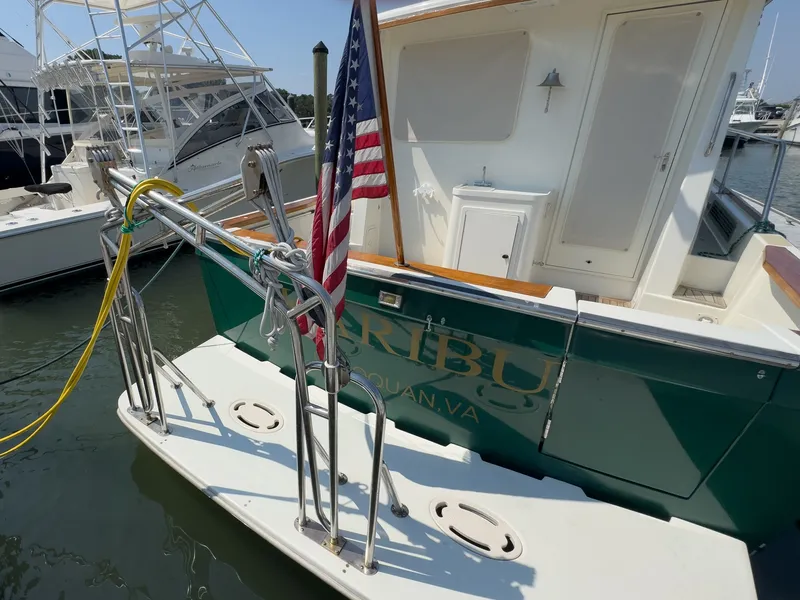 Slide: The Image of The 2002 Sabre 36 Express boat is docked. An American flag is flying at the stern. - 48