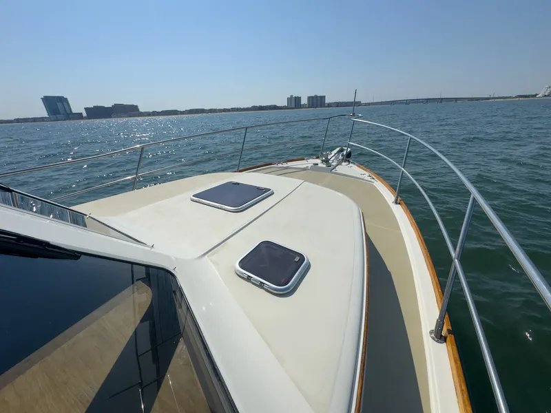 Slide: The Image of The deck of a 2002 Sabre 36 Express on the water with a city skyline in the background. - 40