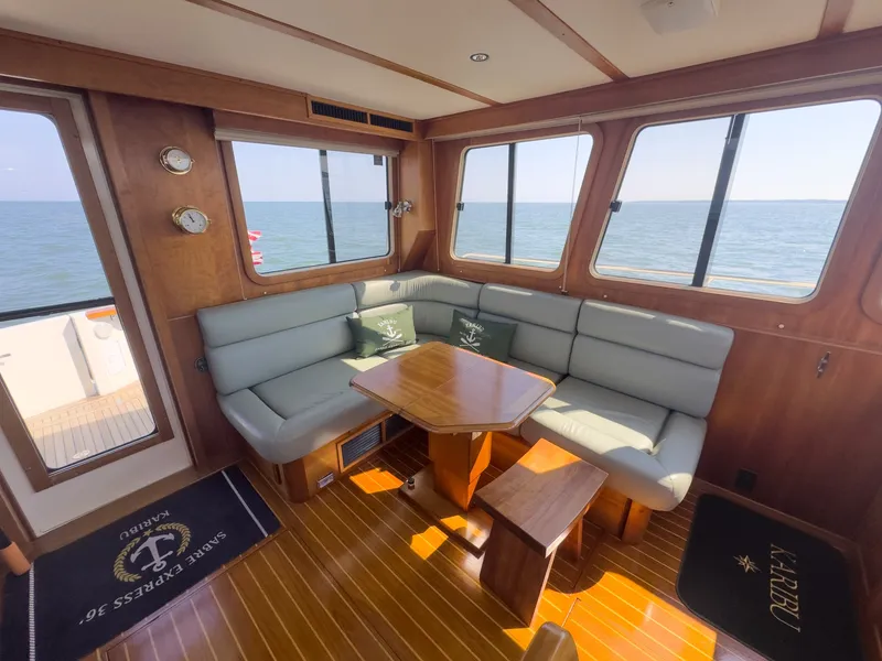 Slide: The Image of Interior of the 2002 Sabre 36 Express with cozy seating area and wooden table. - 9