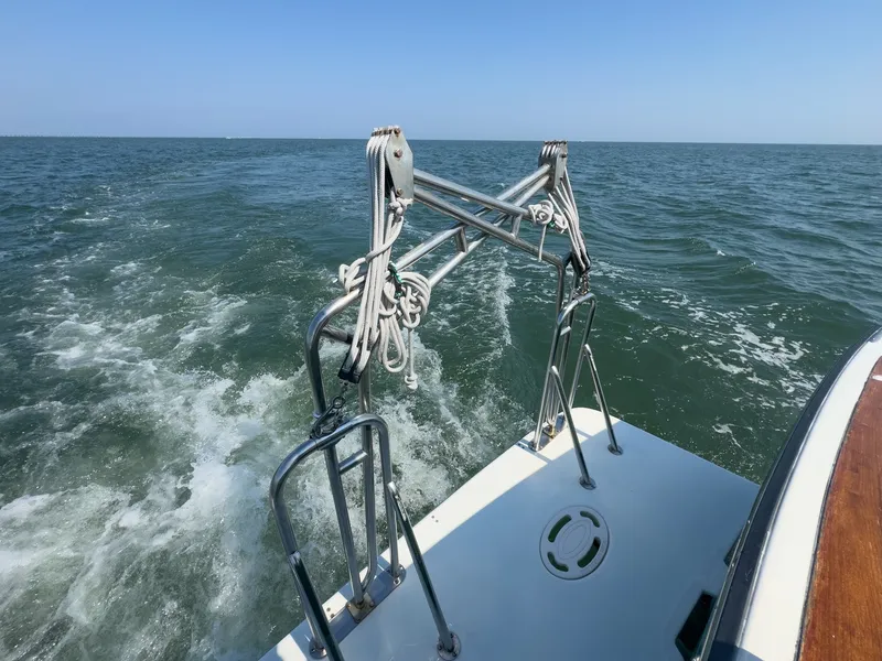 Slide: The Image of The image shows the stern of a 2002 Sabre 36 Express boat on the water. - 35