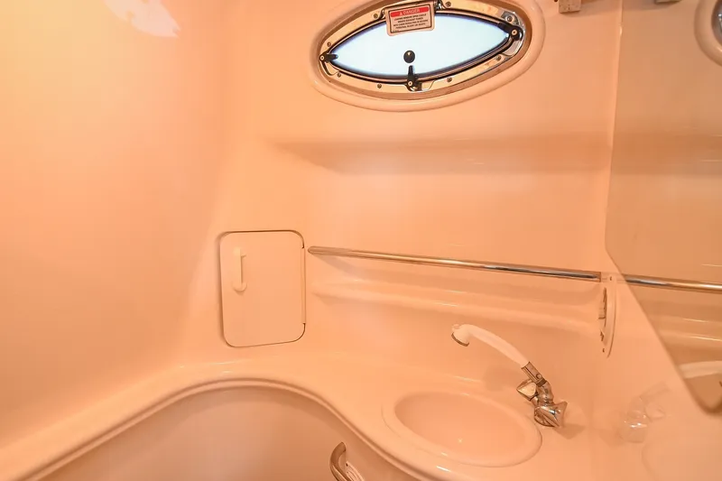 Slide: The Image of 2001 Sea Ray 340 Sundancer bathroom interior with sink and porthole window. - 44