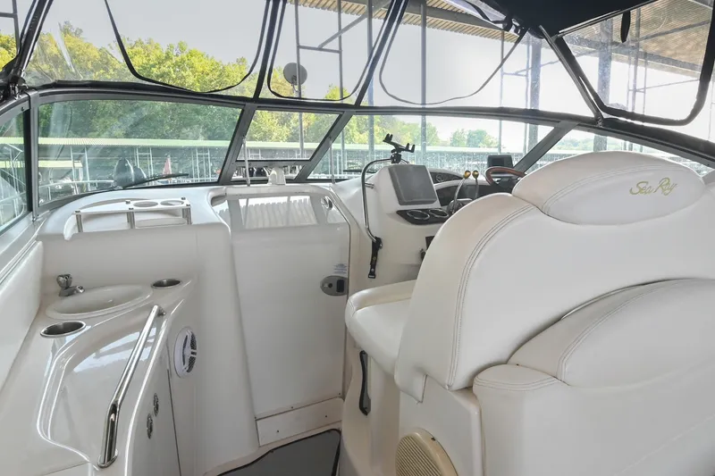 Slide: The Image of Interior view of 2001 Sea Ray 340 Sundancer boat cockpit with white seating and controls. - 15