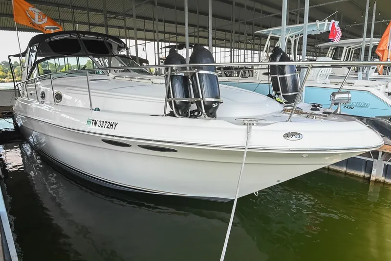 Slide: The Image of 2001 Sea Ray 340 Sundancer docked in a marina, featuring sleek white design. - 3