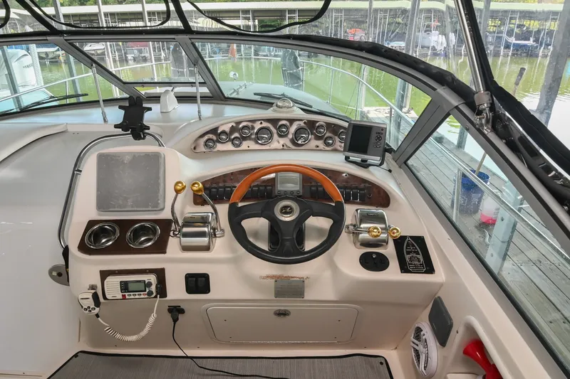 Slide: The Image of Cockpit of 2001 Sea Ray 340 Sundancer with steering wheel and control panel. - 16