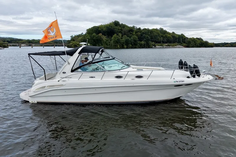 Slide: The Image of 2001 Sea Ray 340 Sundancer boat on a lake with trees in the background. - 66