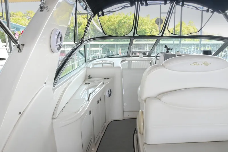 Slide: The Image of Interior of 2001 Sea Ray 340 Sundancer boat with white seating and helm area. - 12