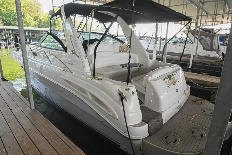Slide: The Image of 2001 Sea Ray 340 Sundancer docked in a marina, featuring sleek white design. - 1