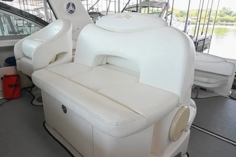 Slide: The Image of 2001 Sea Ray 340 Sundancer interior with white leather seating and scenic marina view. - 18