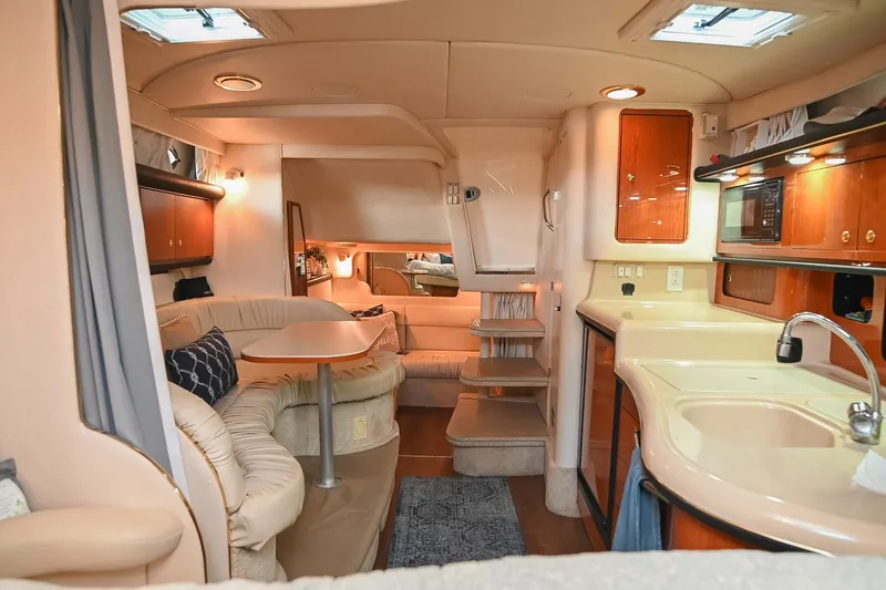 Slide: The Image of Interior of 2001 Sea Ray 340 Sundancer yacht with kitchen and seating area. - 25
