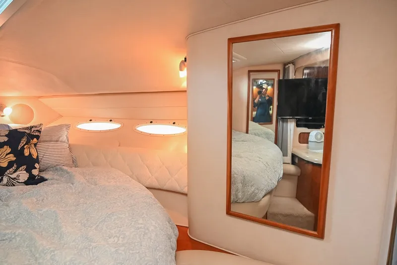 Slide: The Image of Interior cabin of 2001 Sea Ray 340 Sundancer with cozy bed and mirror. - 35