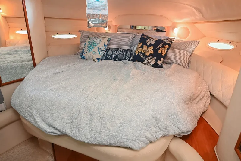 Slide: The Image of Cozy cabin interior of 2001 Sea Ray 340 Sundancer with plush bedding and decorative pillows. - 37