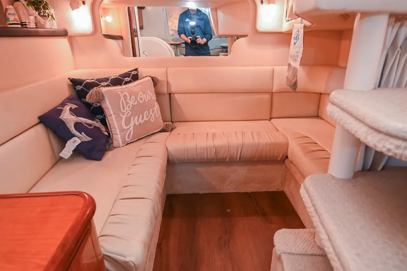 Slide: The Image of Interior of 2001 Sea Ray 340 Sundancer with cozy seating and decorative pillows. - 39