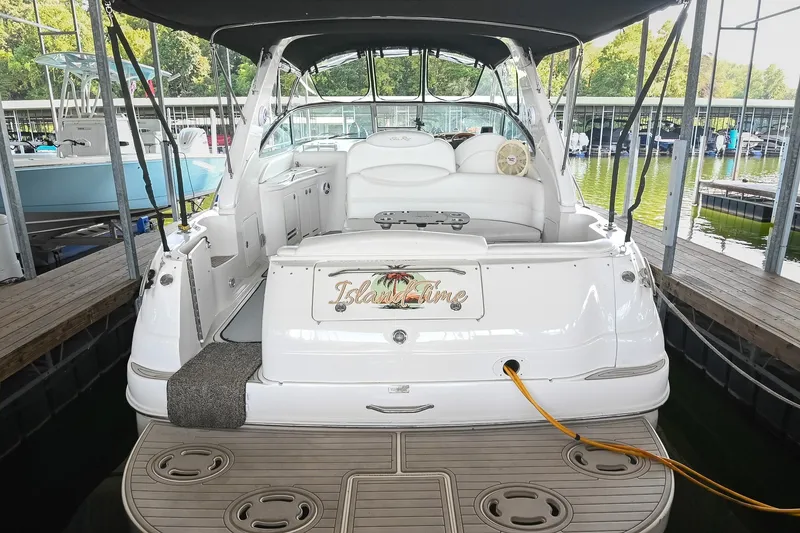 Slide: The Image of 2001 Sea Ray 340 Sundancer docked, featuring spacious seating and elegant design. - 4