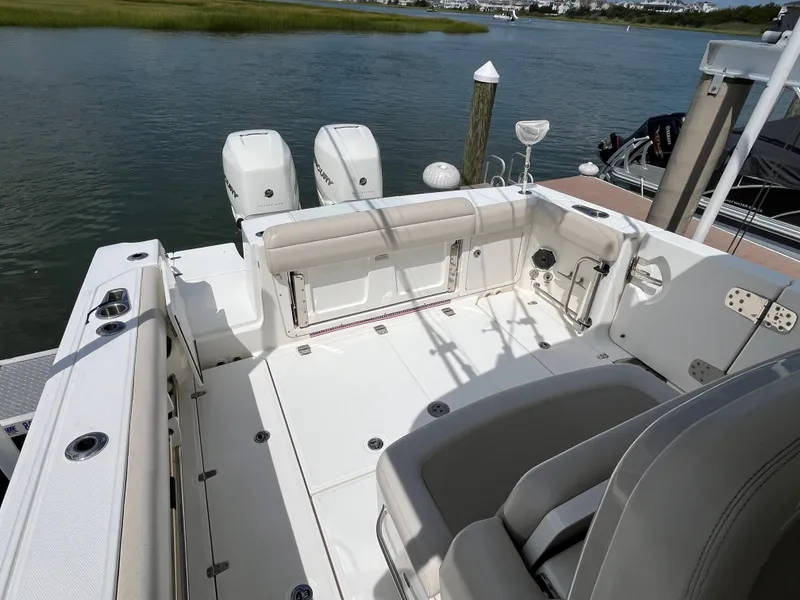 Slide: The Image of The image shows the cockpit of a 2019 Boston Whaler 330 Outrage with two outboard engines. - 14