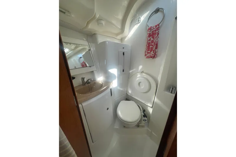 Slide: The Image of Compact bathroom in 2006 Jeanneau Sun Odyssey 45 yacht, featuring sink, toilet, and mirror. - 13
