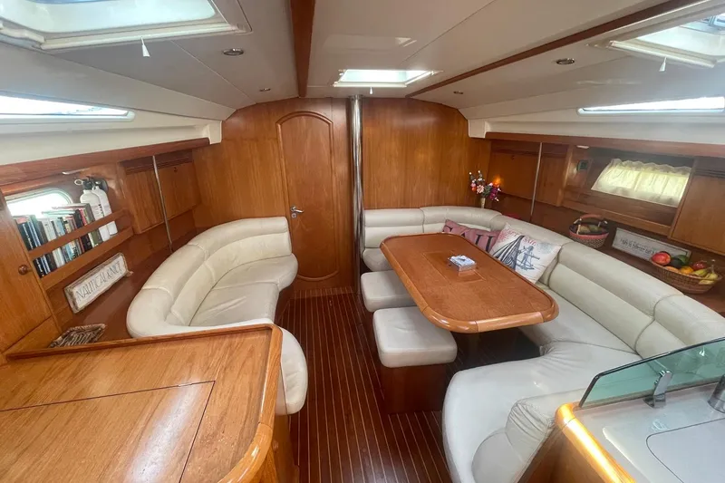 Slide: The Image of Luxurious interior of 2006 Jeanneau Sun Odyssey 45 yacht with elegant wood finish and plush seating. - 19