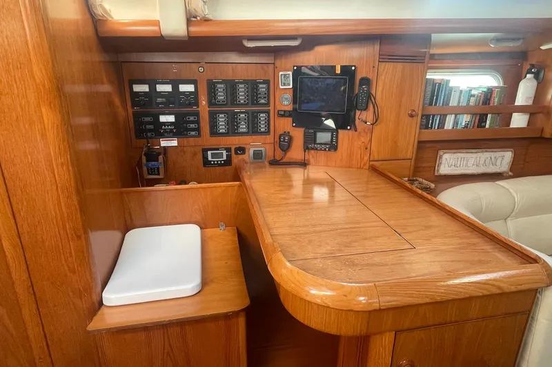 Slide: The Image of Interior of 2006 Jeanneau Sun Odyssey 45 sailboat with navigation station and wooden cabinetry. - 16