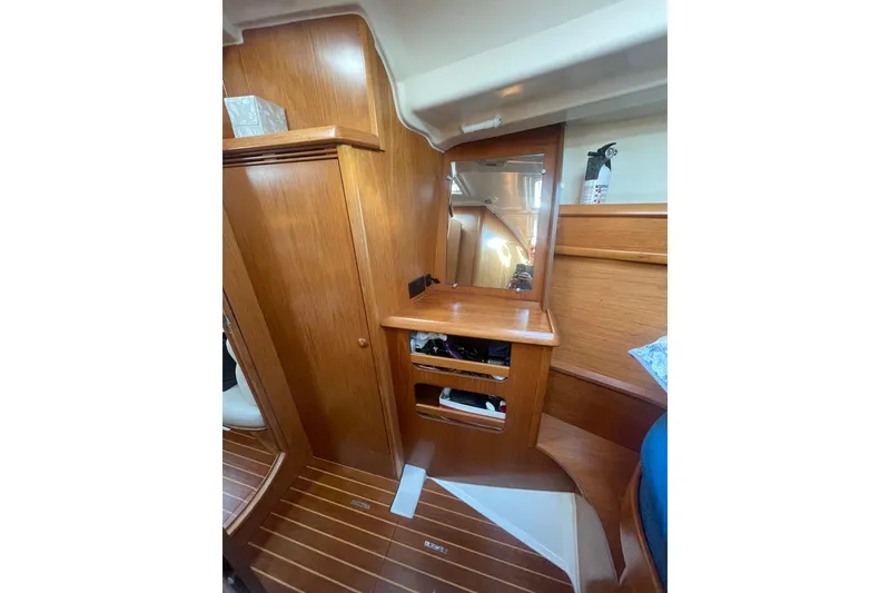 Slide: The Image of Interior of 2006 Jeanneau Sun Odyssey 45 yacht with wooden cabinetry and mirror. - 18