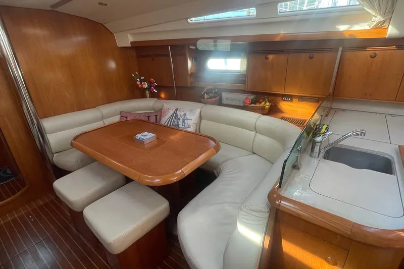 Slide: The Image of Luxurious interior of 2006 Jeanneau Sun Odyssey 45 yacht with elegant dining area and kitchen. - 14