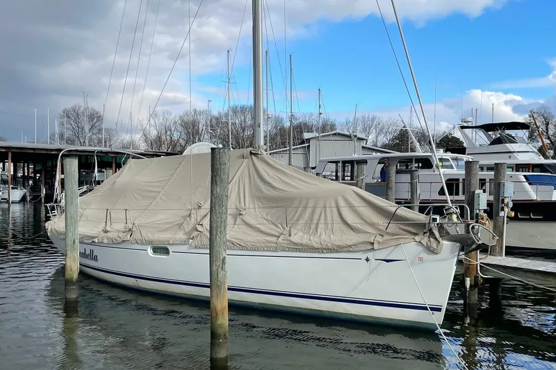 Slide: The Image of Jeanneau Sun Odyssey 45 sailboat, 2006 model, docked with protective cover in marina. - 21